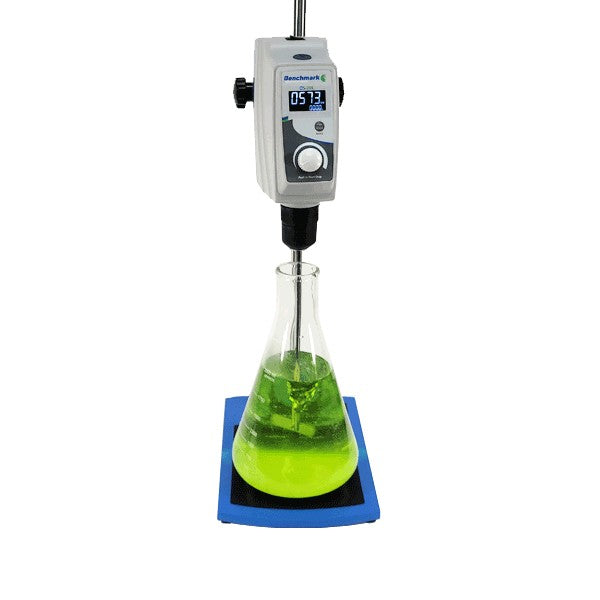 Lab beaker with green liquid being stirred by a digital stirrer on a white background